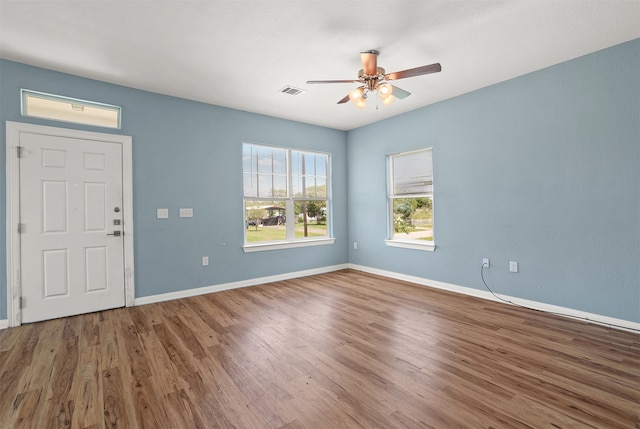 interior space featuring dark wood-type flooring and ceiling fan