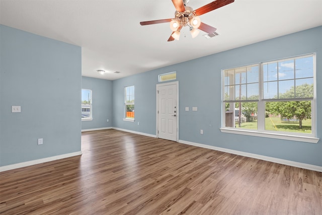 spare room with ceiling fan and hardwood / wood-style flooring