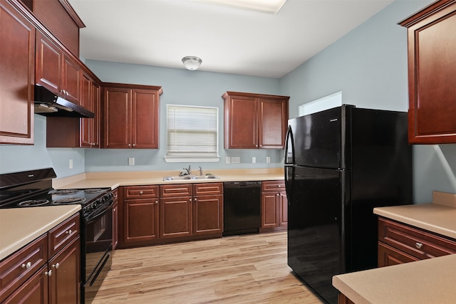 kitchen with black appliances, sink, and light hardwood / wood-style floors