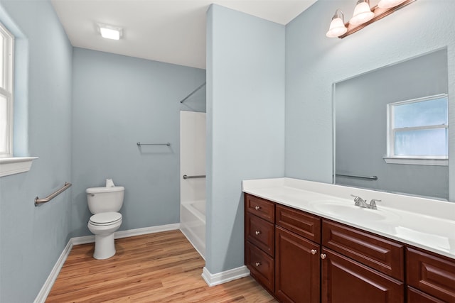 full bathroom with shower / bathing tub combination, wood-type flooring, toilet, and vanity with extensive cabinet space