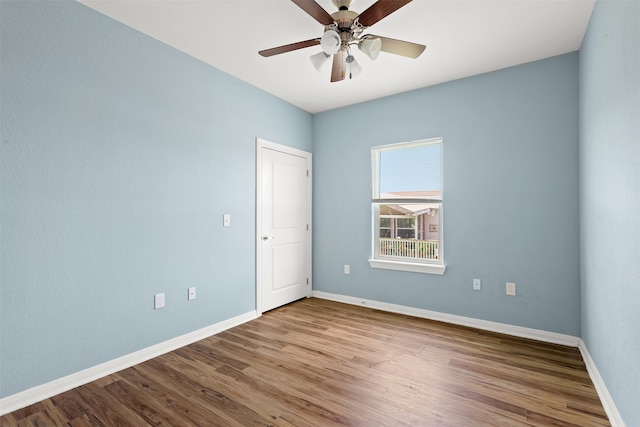 spare room with ceiling fan and hardwood / wood-style floors