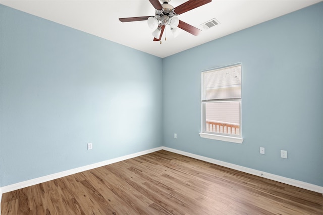 empty room featuring hardwood / wood-style floors and ceiling fan