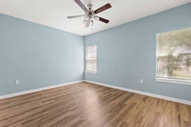 empty room with hardwood / wood-style floors and ceiling fan