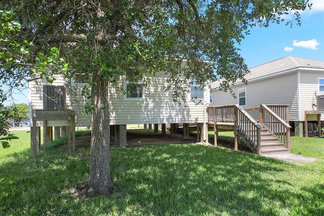 back of house with a wooden deck and a yard