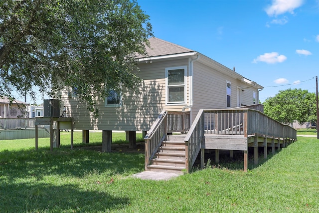 rear view of house with a lawn and a deck