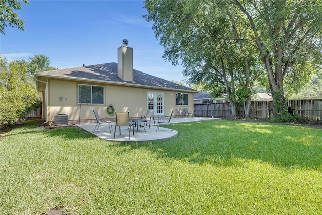 rear view of house featuring a yard, central AC, and a patio