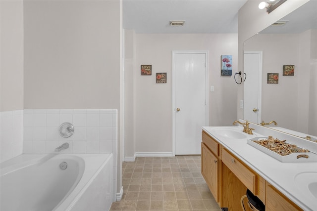 bathroom featuring vanity and a tub