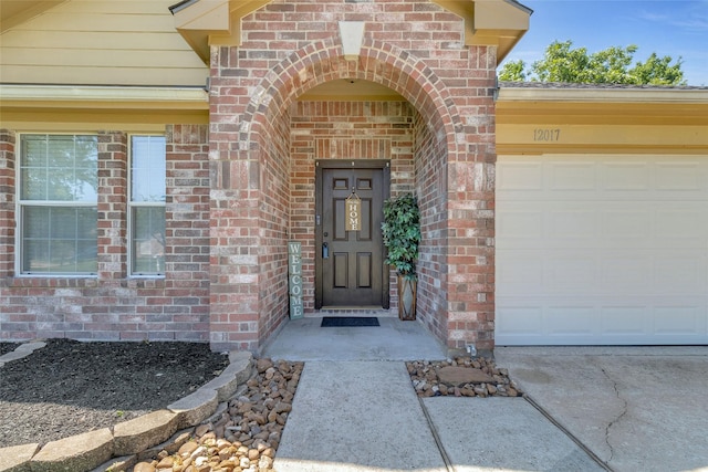 view of exterior entry featuring a garage