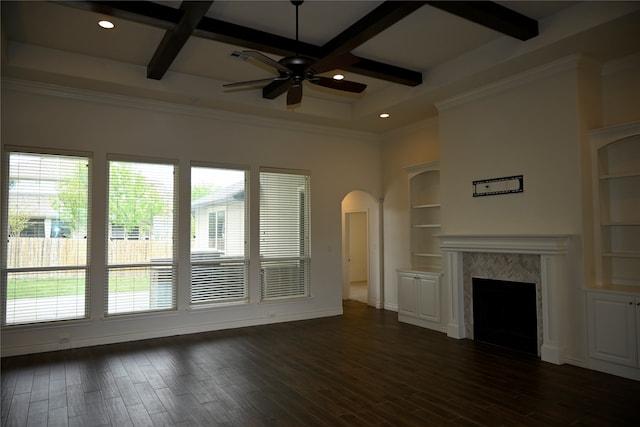 unfurnished living room with a wealth of natural light, coffered ceiling, dark hardwood / wood-style floors, and a fireplace