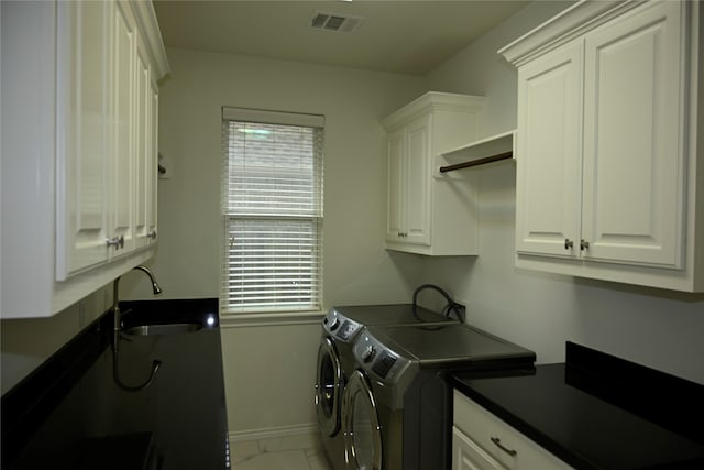 laundry room featuring cabinets, sink, independent washer and dryer, and light tile floors