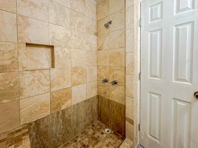 bathroom with tiled shower