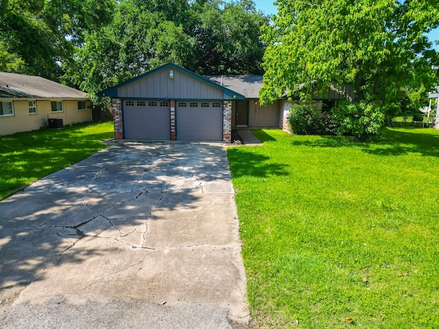 single story home featuring a garage and a front lawn