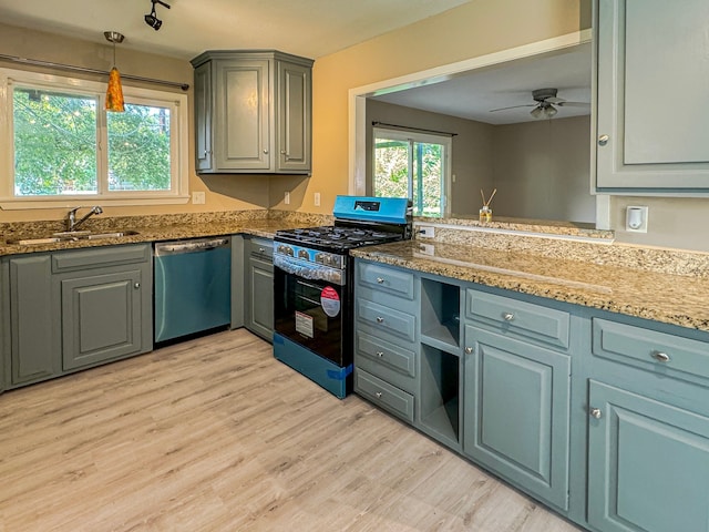 kitchen featuring dishwasher, ceiling fan, gas stove, light wood-type flooring, and pendant lighting