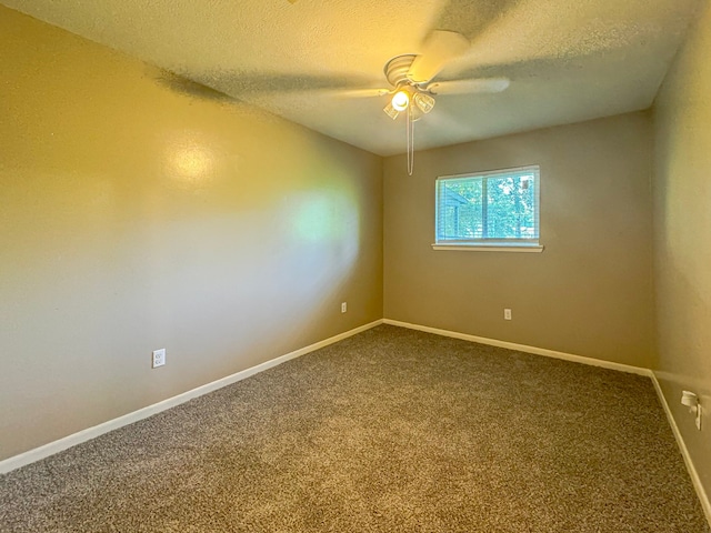 spare room featuring carpet, ceiling fan, and a textured ceiling