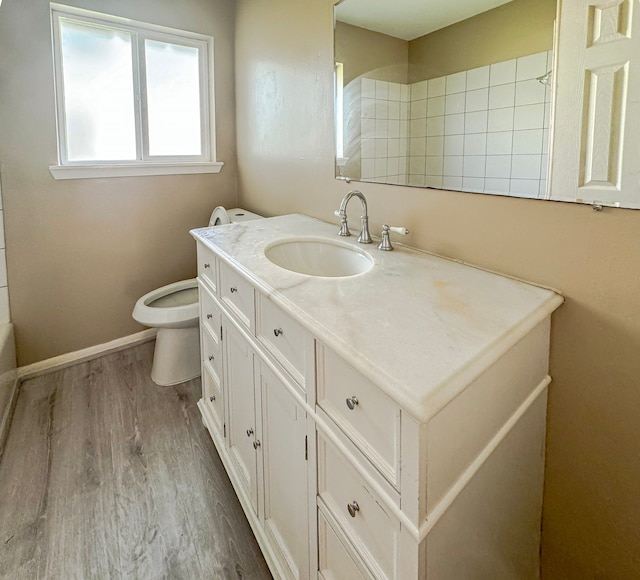 full bathroom with shower / bath combination, hardwood / wood-style flooring, toilet, and vanity