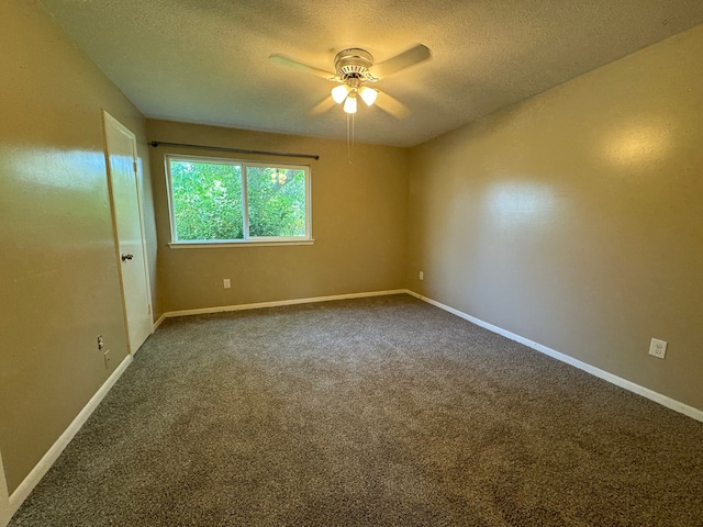 carpeted spare room with a textured ceiling and ceiling fan