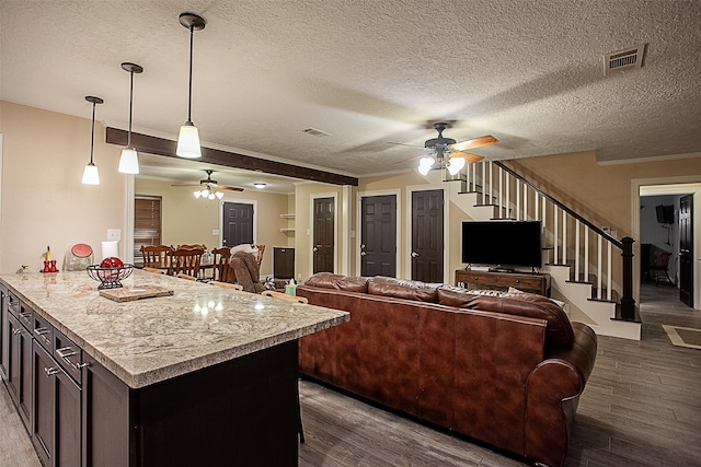 interior space with hardwood / wood-style floors, ceiling fan, and a textured ceiling