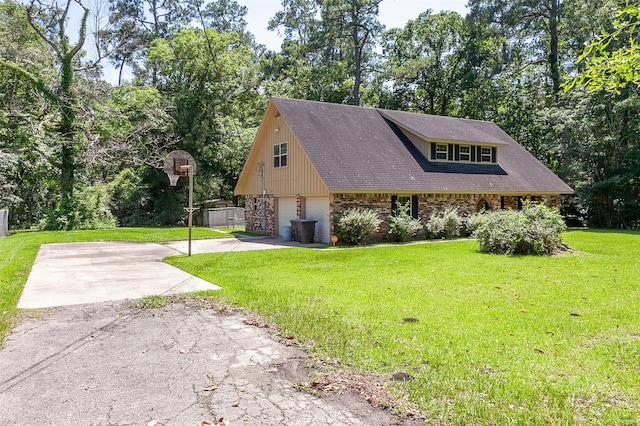 view of front of home with a garage and a front lawn