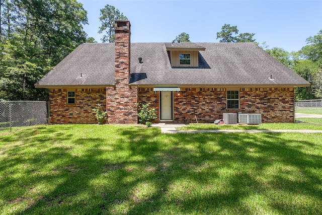 exterior space with central AC and a front lawn