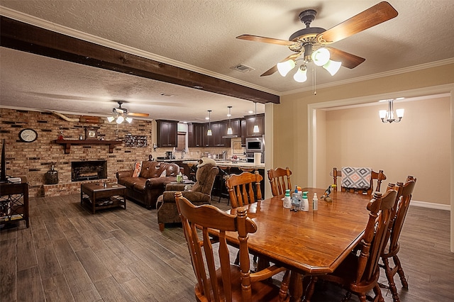 dining room with a fireplace, brick wall, ceiling fan with notable chandelier, and dark hardwood / wood-style flooring