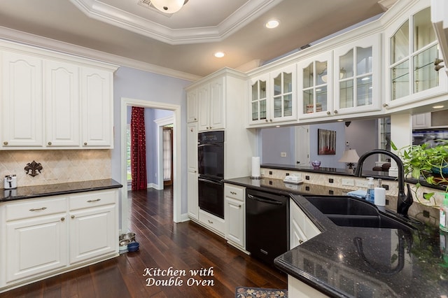 kitchen with dark wood-type flooring, white cabinets, black appliances, and a raised ceiling