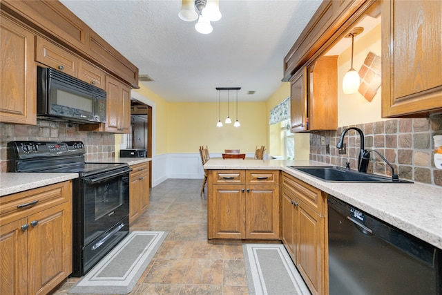 kitchen with decorative light fixtures, light tile flooring, tasteful backsplash, and black appliances