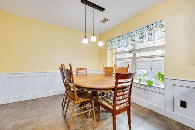 dining space with dark tile flooring