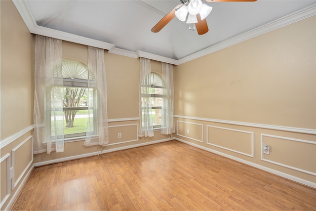 empty room with ornamental molding, ceiling fan, light wood-type flooring, and lofted ceiling