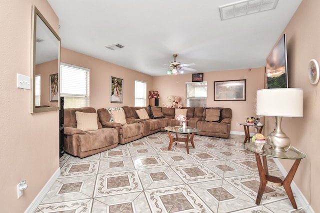 living room with light tile flooring and ceiling fan