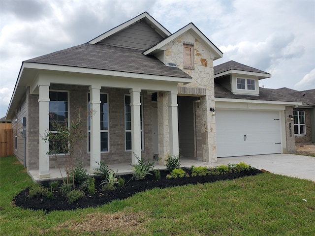 view of front of home with a front yard and a garage