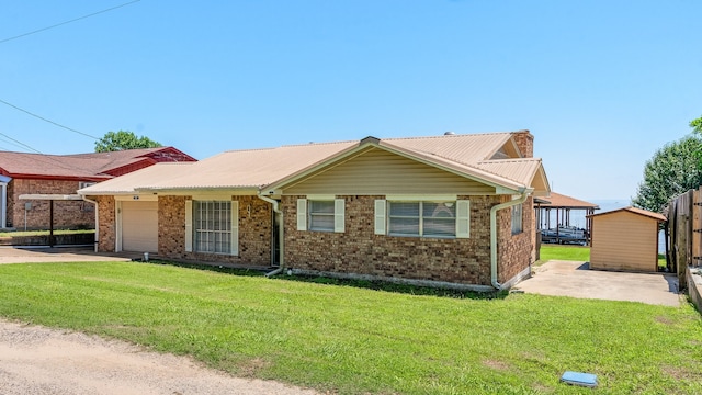 ranch-style home featuring a garage and a front lawn