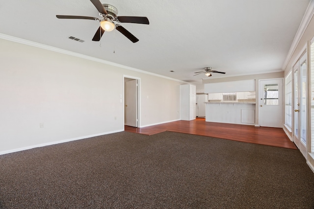 unfurnished living room with hardwood / wood-style floors, ornamental molding, and ceiling fan