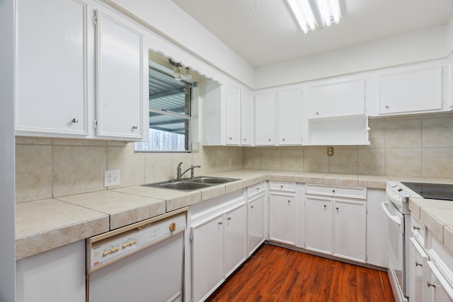 kitchen with sink, dark wood-type flooring, white appliances, tasteful backsplash, and white cabinets