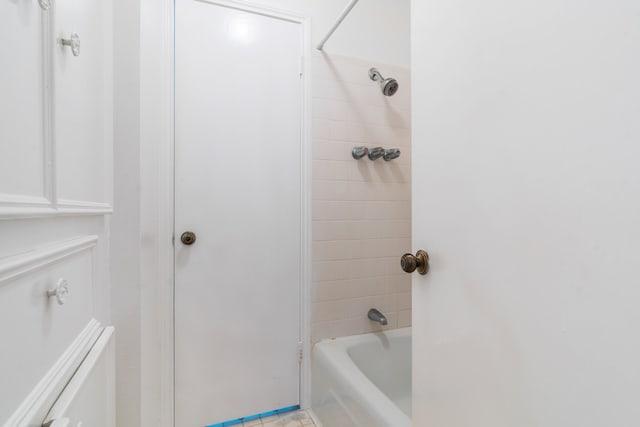 bathroom featuring tiled shower / bath and tile patterned flooring