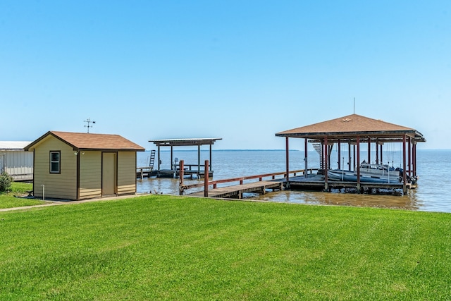 view of dock featuring a lawn and a water view