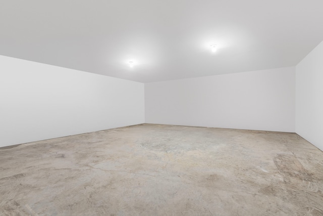 unfurnished room with concrete flooring