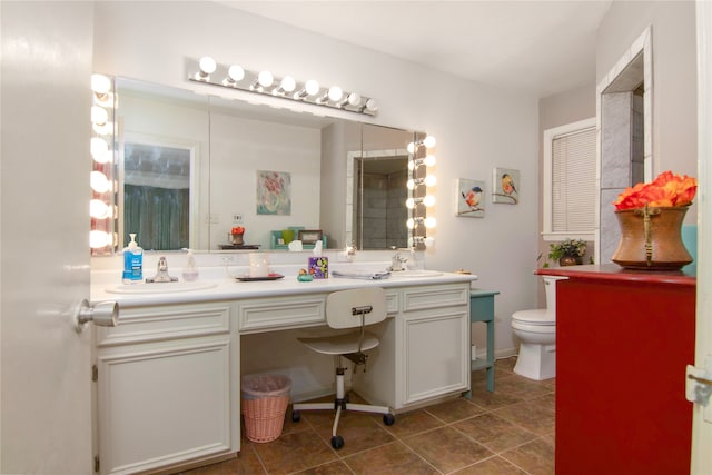 bathroom with tile flooring, dual vanity, and toilet