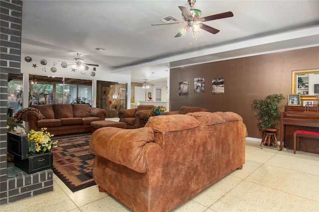 living room with ceiling fan and a wood stove