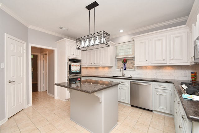 kitchen featuring dishwasher, backsplash, a center island, white cabinetry, and sink