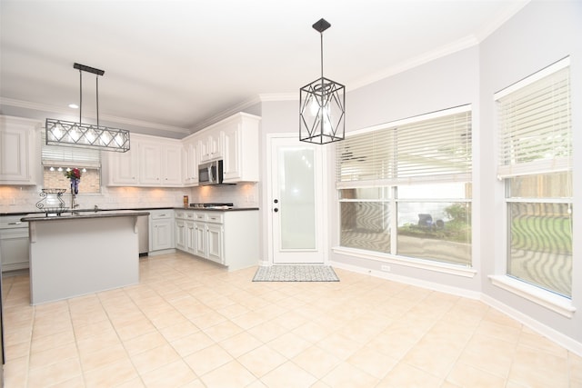 kitchen with white cabinets, hanging light fixtures, tasteful backsplash, and light tile floors