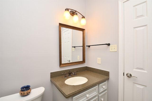 bathroom featuring toilet and vanity