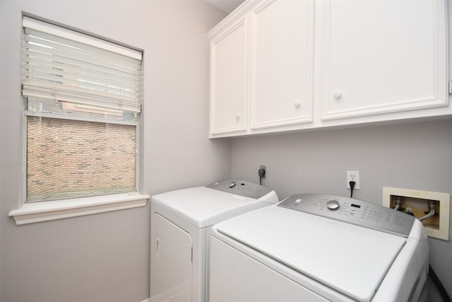 laundry room with cabinets, hookup for an electric dryer, washer hookup, and washing machine and clothes dryer