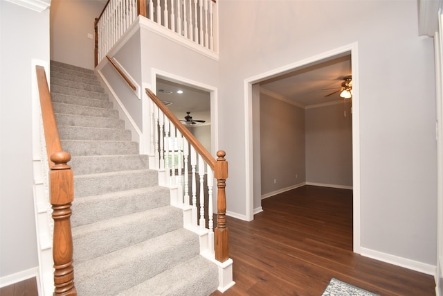 entrance foyer with crown molding, ceiling fan, and dark hardwood / wood-style flooring