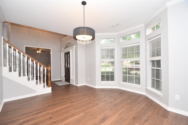 interior space with a healthy amount of sunlight, ornamental molding, dark hardwood / wood-style floors, and ceiling fan