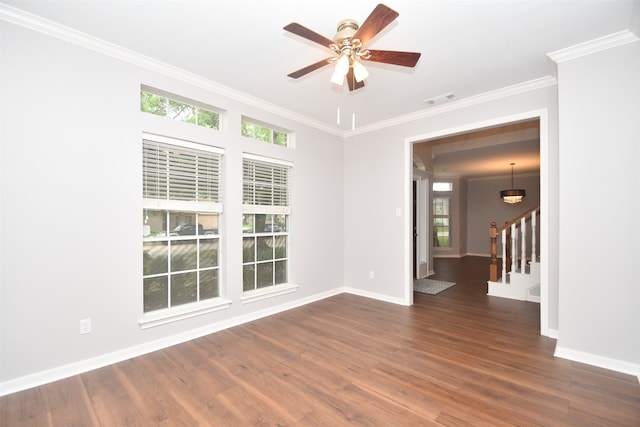 empty room featuring dark hardwood / wood-style floors, plenty of natural light, ceiling fan, and crown molding