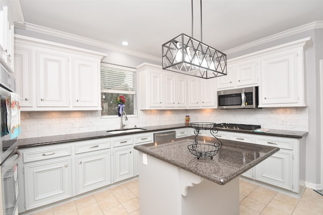 kitchen with ornamental molding, a kitchen island, stainless steel appliances, white cabinets, and sink