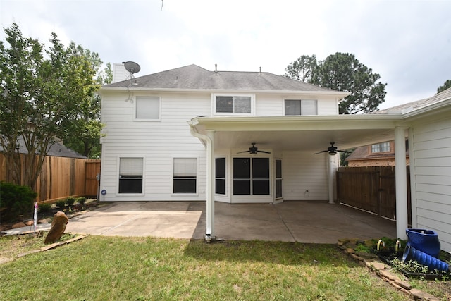 rear view of property featuring ceiling fan, a lawn, and a patio area