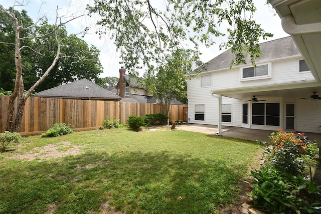 view of yard with ceiling fan and a patio