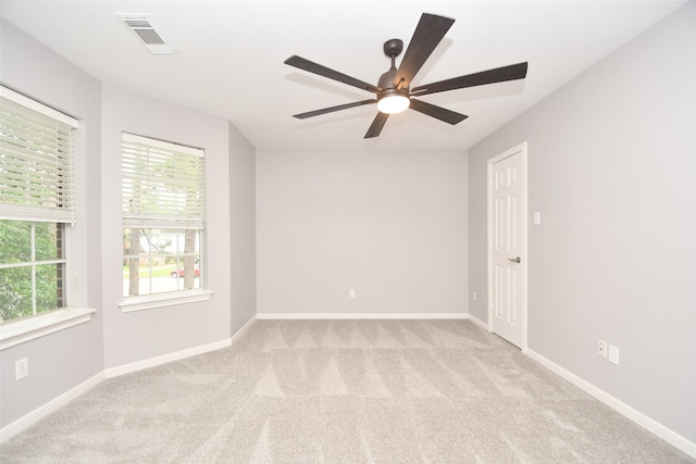 carpeted spare room featuring ceiling fan