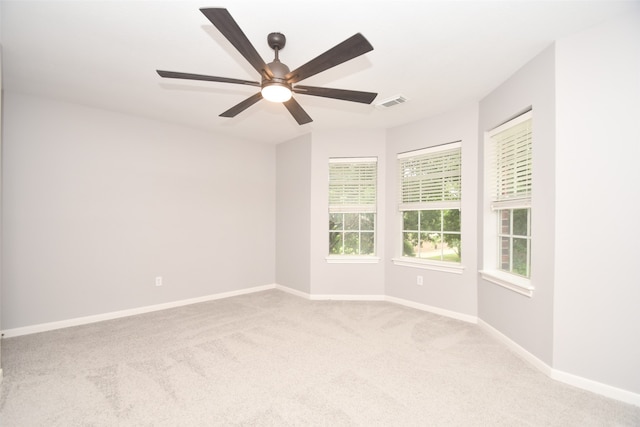 unfurnished room with carpet and ceiling fan